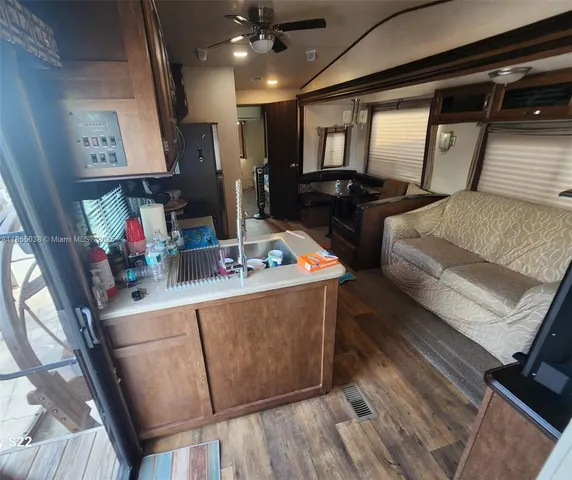 a bathroom with a granite countertop toilet sink and mirror