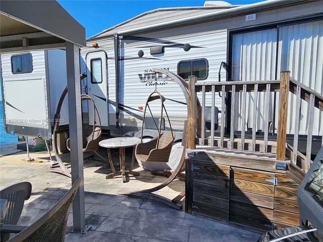 a view of a patio with dining table and chairs under an umbrella