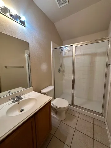 a bathroom with a sink toilet a mirror and shower