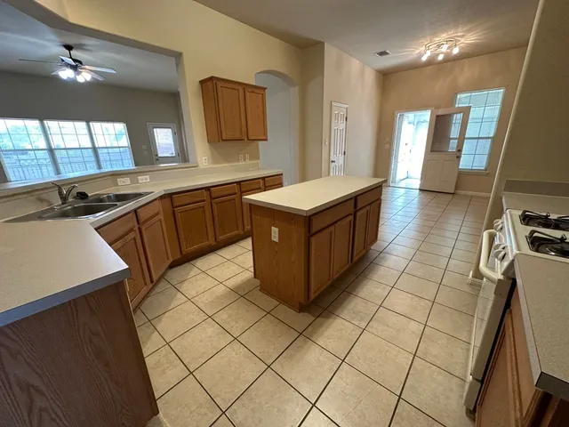 a kitchen with stainless steel appliances a sink stove and cabinets