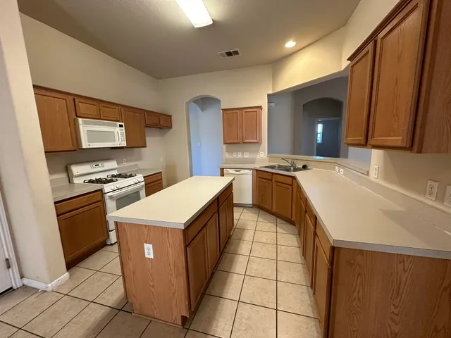 a kitchen that has a sink and a stove in it