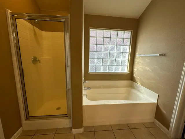 a bathroom with a bathtub and a shower