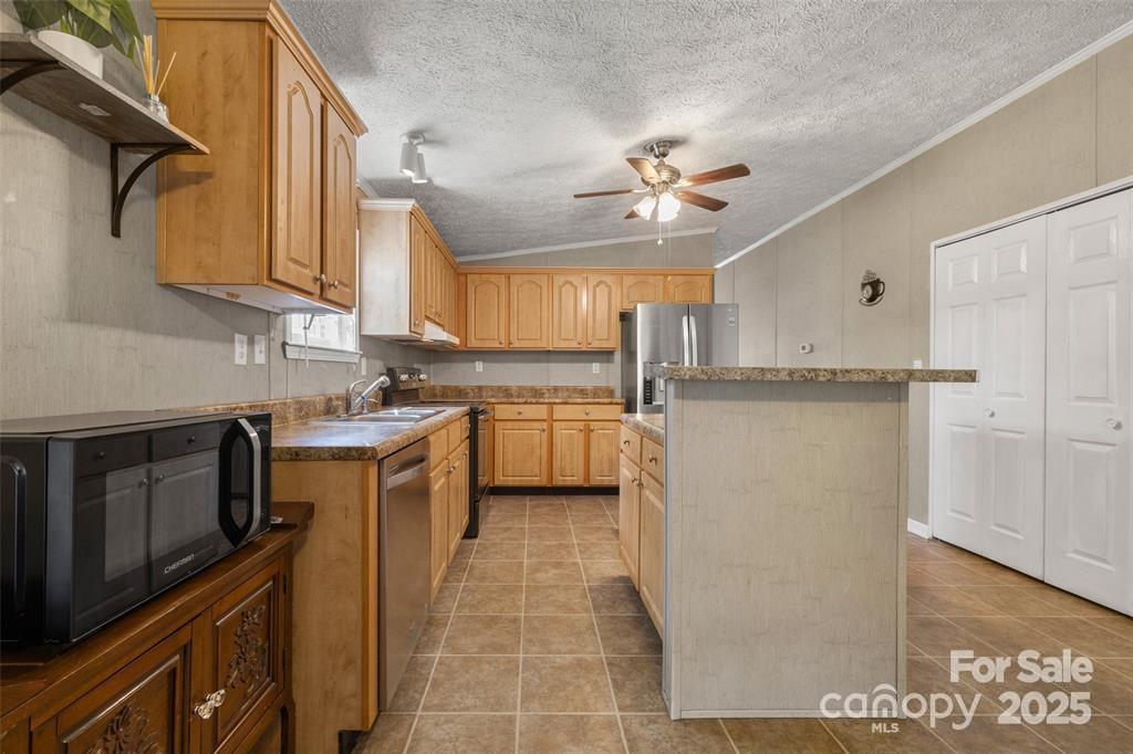 3478 Cool Branch Road Carlisle, SC 29031 - Photo 11 of 23 a kitchen with a sink cabinets stainless steel appliances and a window