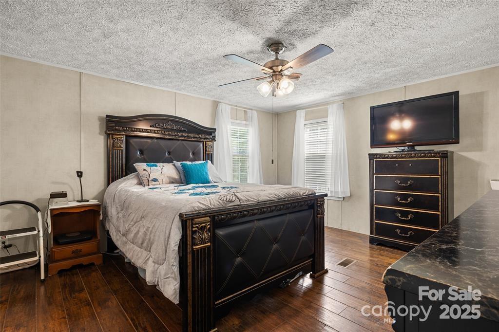 3478 Cool Branch Road Carlisle, SC 29031 - Photo 18 of 23 a bedroom with a bed and a chandelier