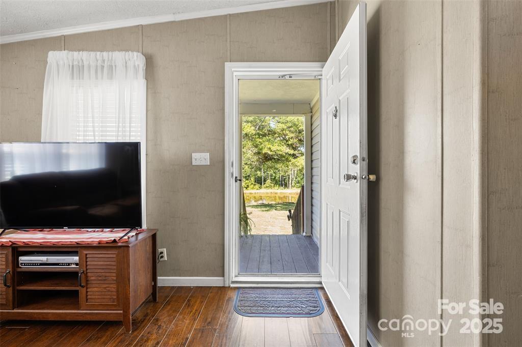 3478 Cool Branch Road Carlisle, SC 29031 - Photo 5 of 23 a room with wooden floor and flat screen tv
