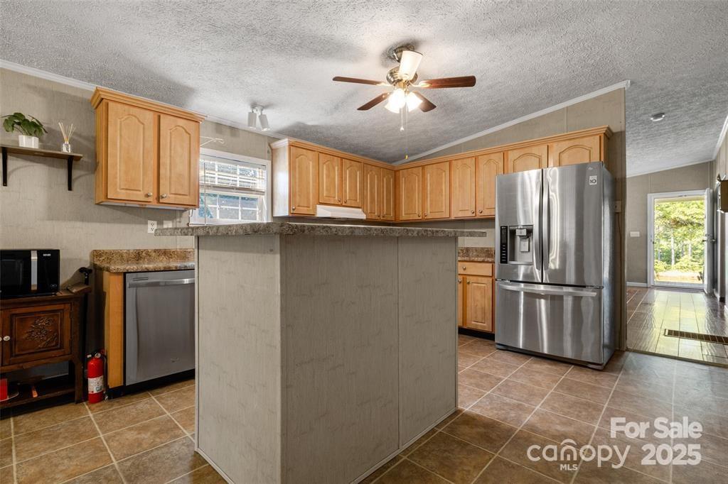 3478 Cool Branch Road Carlisle, SC 29031 - Photo 8 of 23 a kitchen with stainless steel appliances granite countertop a refrigerator a stove a sink and dishwasher with wooden cabinet