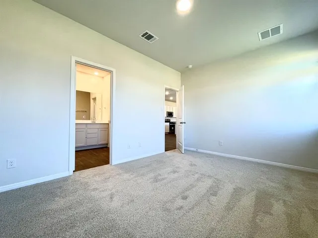 an empty room with closet and wooden floor