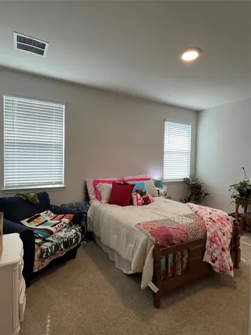 a bedroom with a bed and window