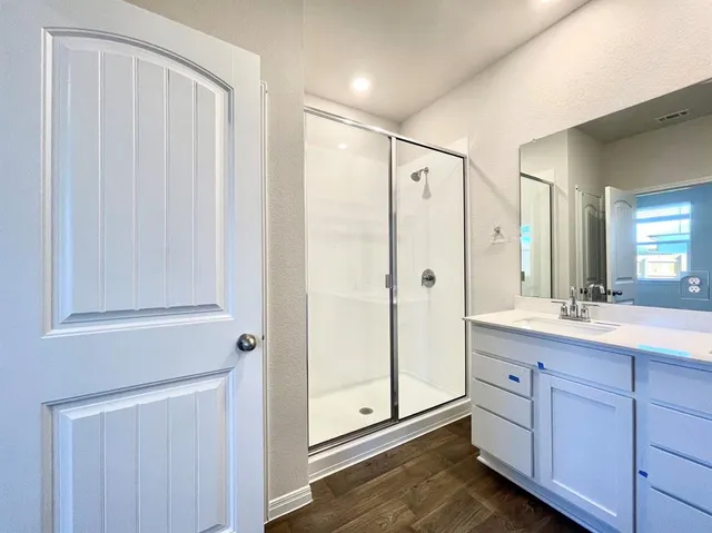 a bathroom with a double vanity sink and mirror
