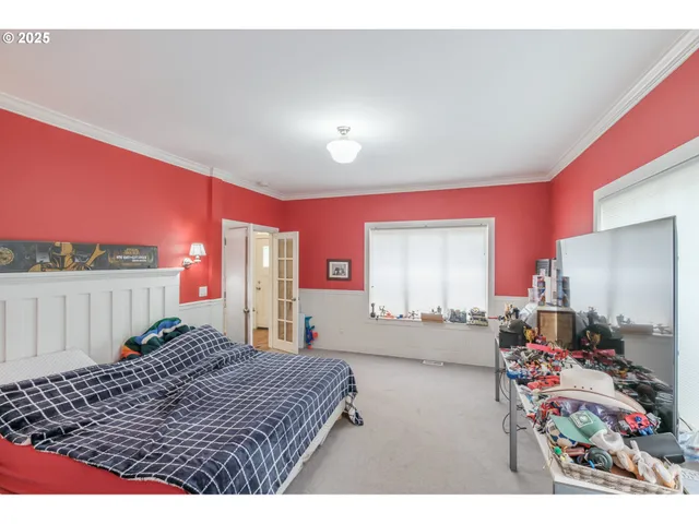 a bed room with a bed window and mirror