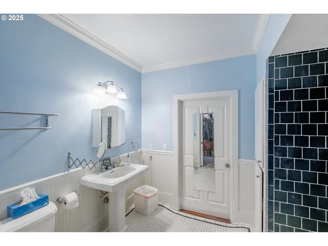 a bathroom with a sink mirror and shower