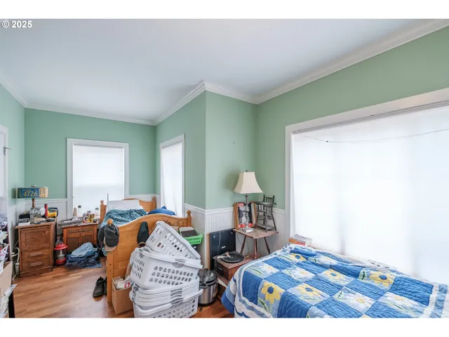 a bedroom with two beds and a lamp