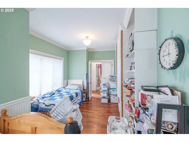a living room with furniture a flat screen tv and a wall painting