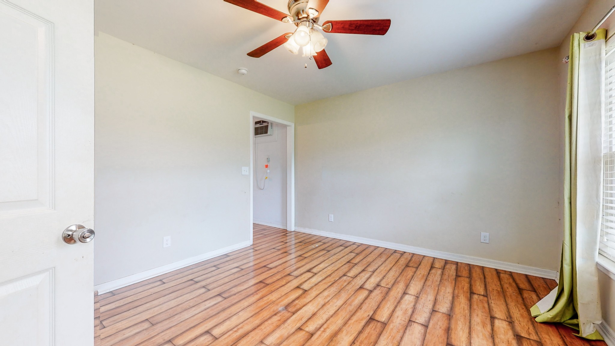 643 Beech Log Road Watertown, TN 37184 - Photo 18 of 31 a view of a room with wooden floor and a ceiling fan