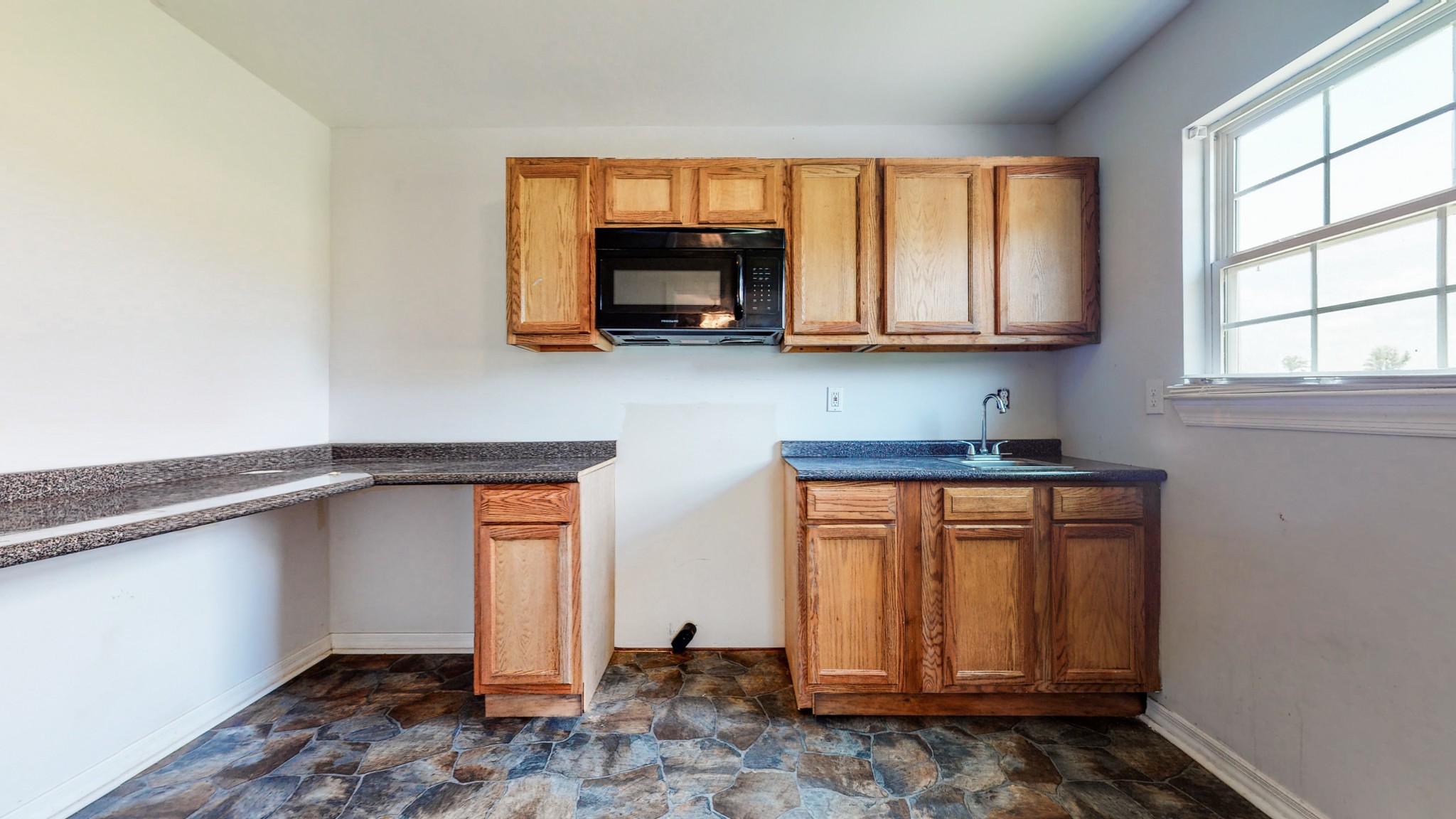 643 Beech Log Road Watertown, TN 37184 - Photo 22 of 31 a kitchen with stainless steel appliances granite countertop a stove a microwave and cabinets