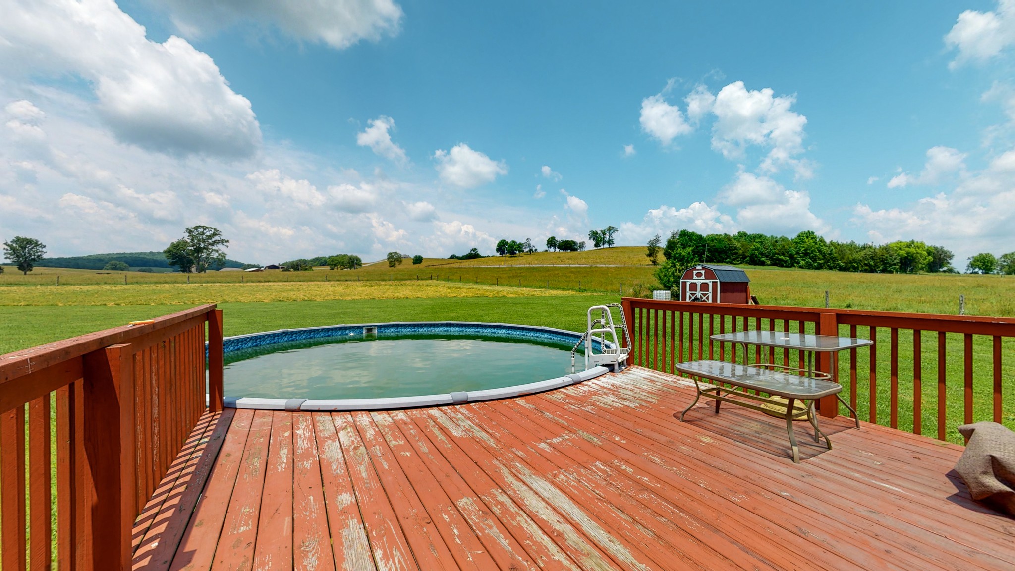 643 Beech Log Road Watertown, TN 37184 - Photo 26 of 31 a view of a swimming pool with a deck and a garden
