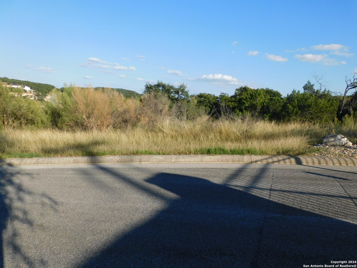 22202 Ravine San Antonio, TX 78255 - Photo 10 of 17 a view of a lake with a yard