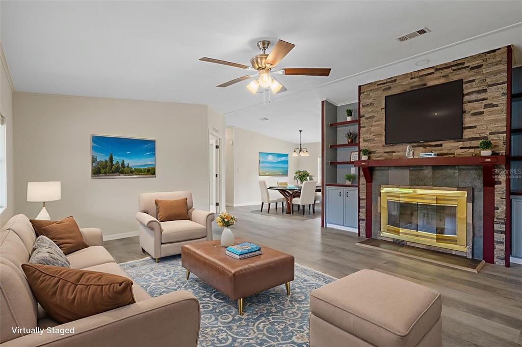 18008 Greensboro Street Spring Hill, FL 34610 - Photo 13 of 49 a living room with furniture a flat screen tv and a fireplace