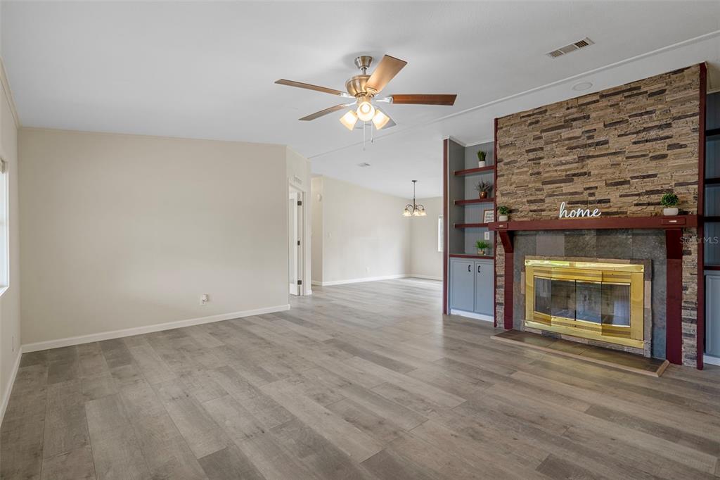 18008 Greensboro Street Spring Hill, FL 34610 - Photo 14 of 49 a view of an empty room with a fireplace and a window