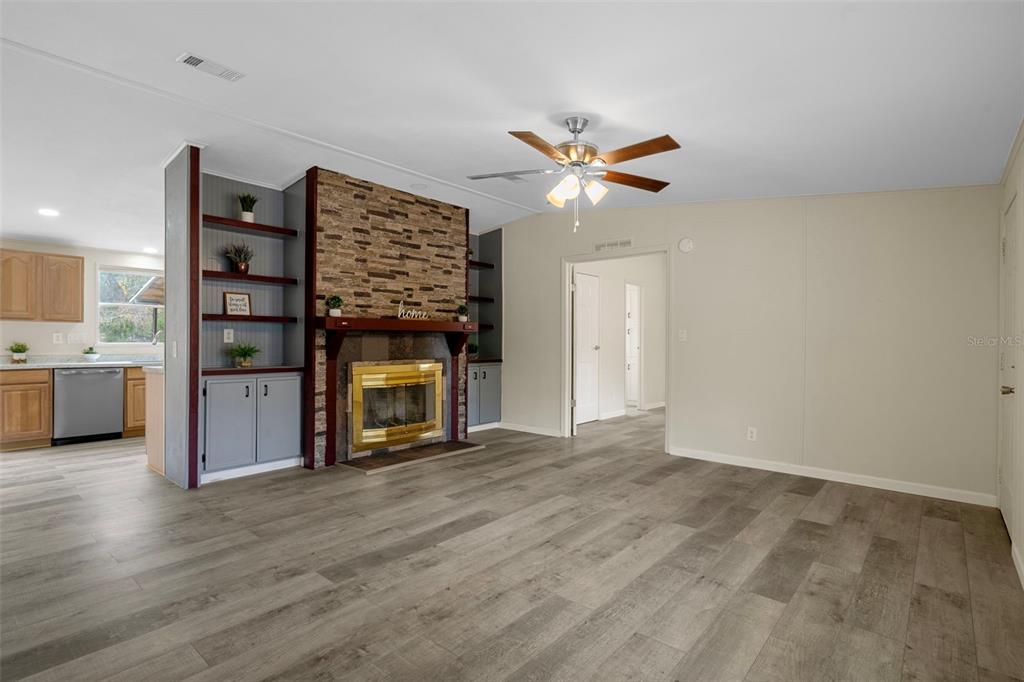18008 Greensboro Street Spring Hill, FL 34610 - Photo 16 of 49 a view of an empty room with a fireplace and a window