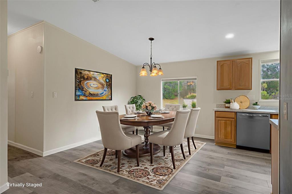 18008 Greensboro Street Spring Hill, FL 34610 - Photo 18 of 49 a dining room with furniture a window and wooden floor