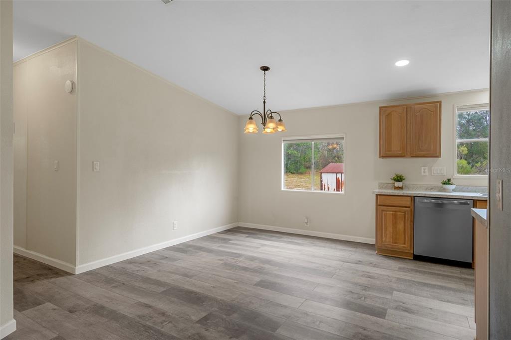 18008 Greensboro Street Spring Hill, FL 34610 - Photo 19 of 49 a view of an empty room with window and wooden floor