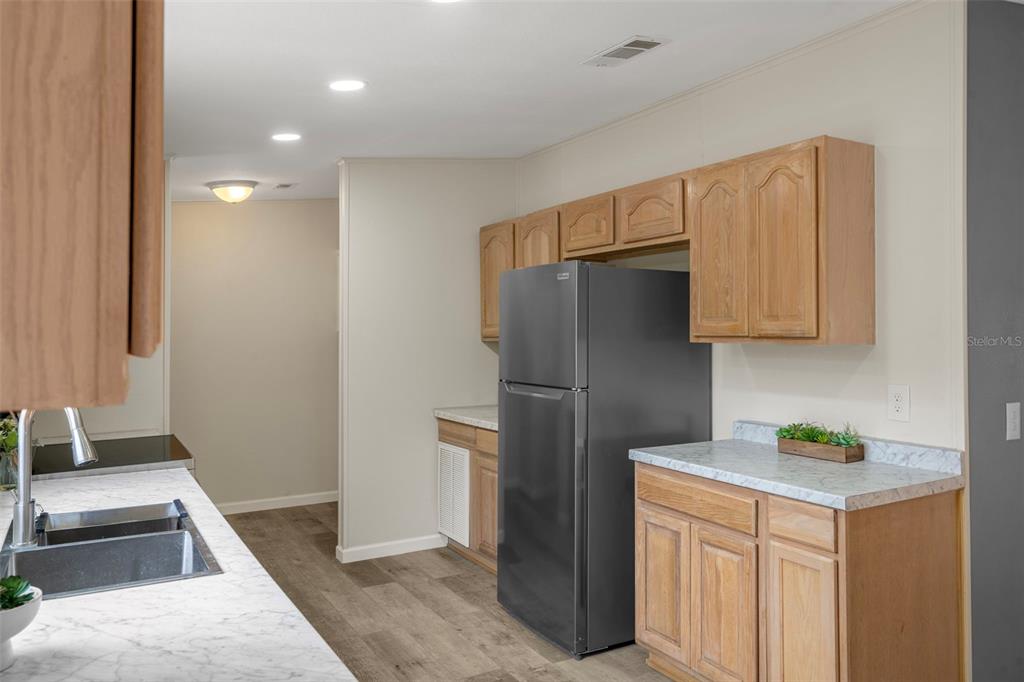 18008 Greensboro Street Spring Hill, FL 34610 - Photo 23 of 49 a kitchen with stainless steel appliances granite countertop a refrigerator and a stove