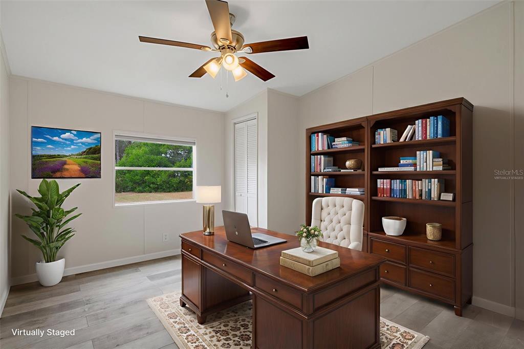 18008 Greensboro Street Spring Hill, FL 34610 - Photo 27 of 49 a view of a workspace with a bookshelf
