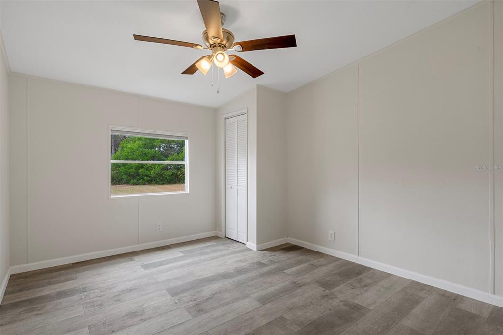 18008 Greensboro Street Spring Hill, FL 34610 - Photo 28 of 49 an empty room with a window and a fan
