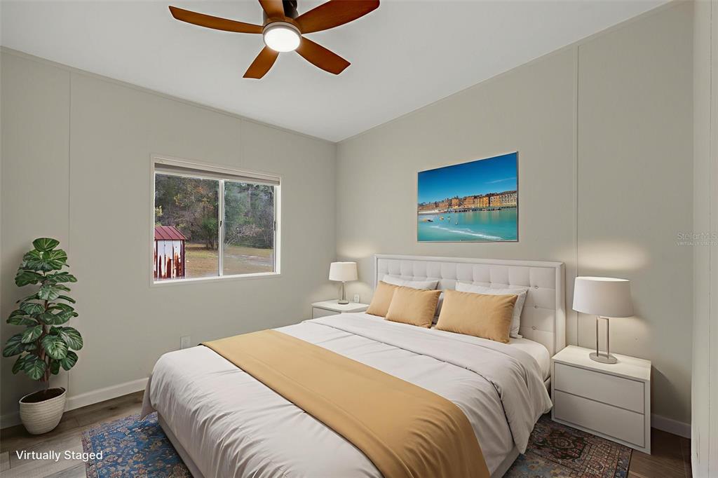 18008 Greensboro Street Spring Hill, FL 34610 - Photo 36 of 49 a bedroom with a bed and a potted plant