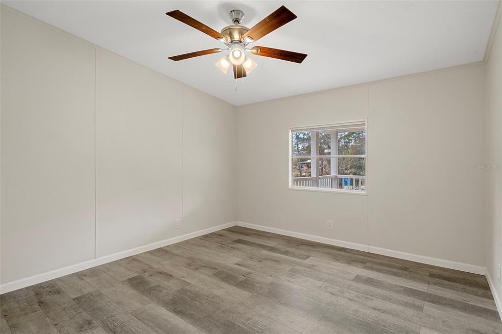 18008 Greensboro Street Spring Hill, FL 34610 - Photo 41 of 49 an empty room with a window and a fan