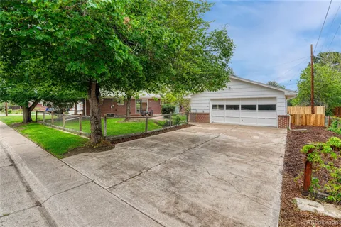 a front view of a house with a yard and a garage