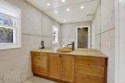 a bathroom with a granite countertop sink a mirror and a vanity