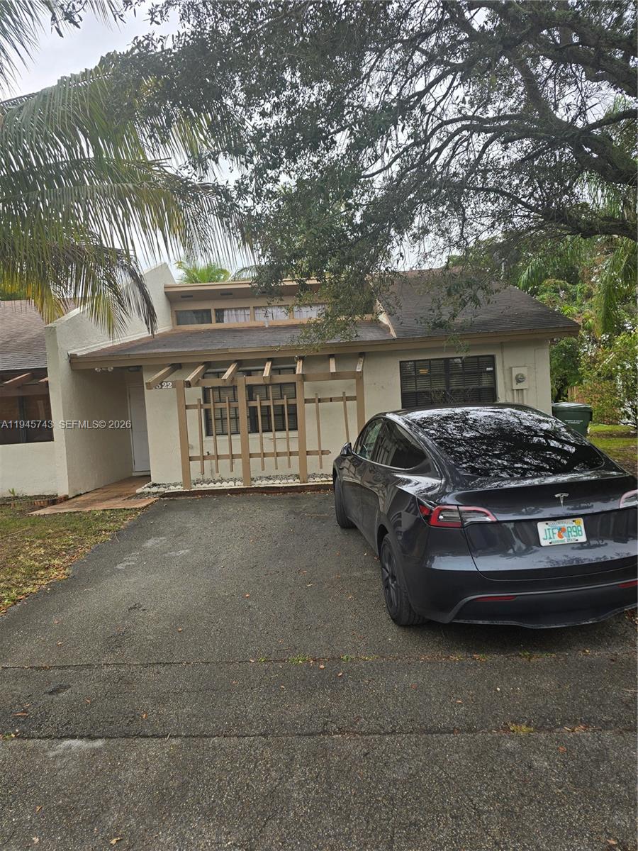 a couple of cars parked in front of a house