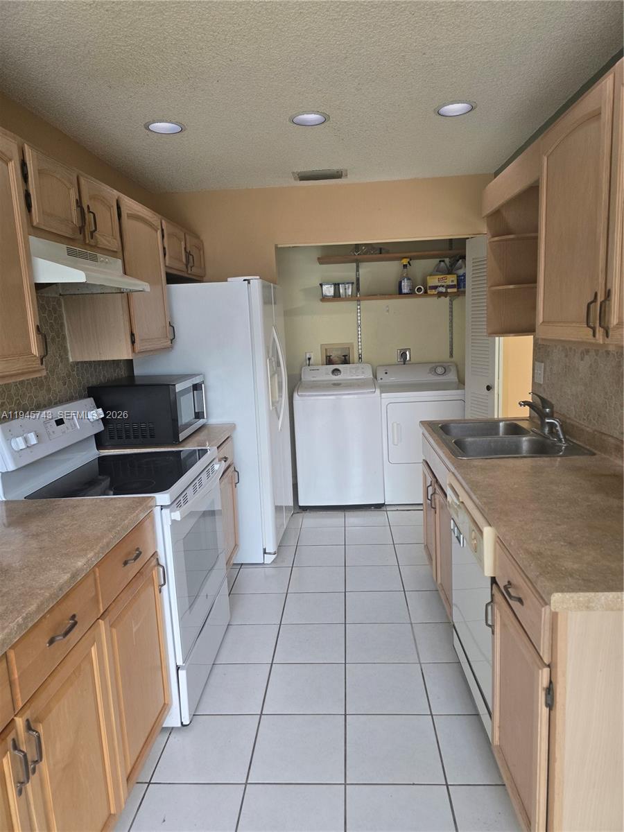 1322 Sandpiper Boulevard, Unit 1 Homestead, FL 33034 - Photo 18 of 25 a kitchen with a sink a stove and cabinets