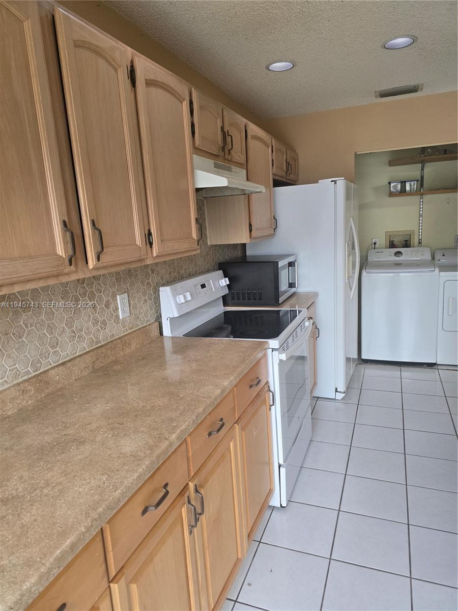 1322 Sandpiper Boulevard, Unit 1 Homestead, FL 33034 - Photo 19 of 25 a kitchen with a sink a stove and cabinets