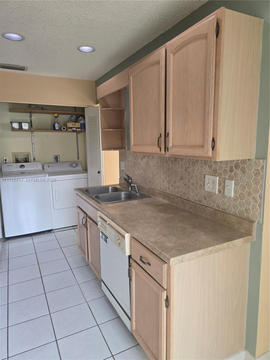 1322 Sandpiper Boulevard, Unit 1 Homestead, FL 33034 - Photo 20 of 25 a kitchen with stainless steel appliances granite countertop a sink stove and cabinets