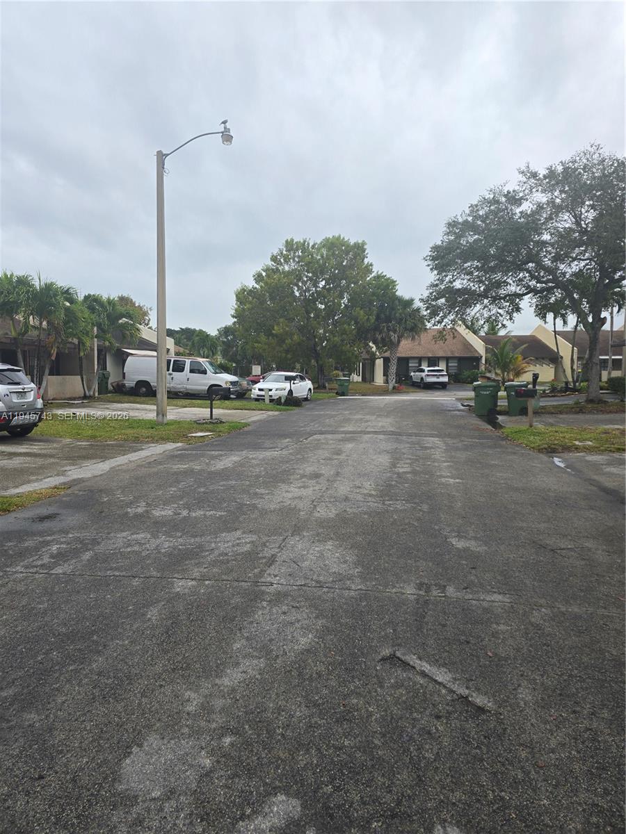 1322 Sandpiper Boulevard, Unit 1 Homestead, FL 33034 - Photo 2 of 25 a view of a field with cars parked in front of it