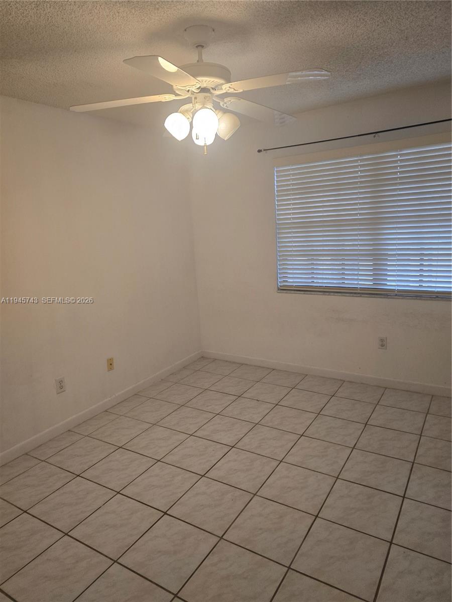 1322 Sandpiper Boulevard, Unit 1 Homestead, FL 33034 - Photo 6 of 25 an empty room with a window
