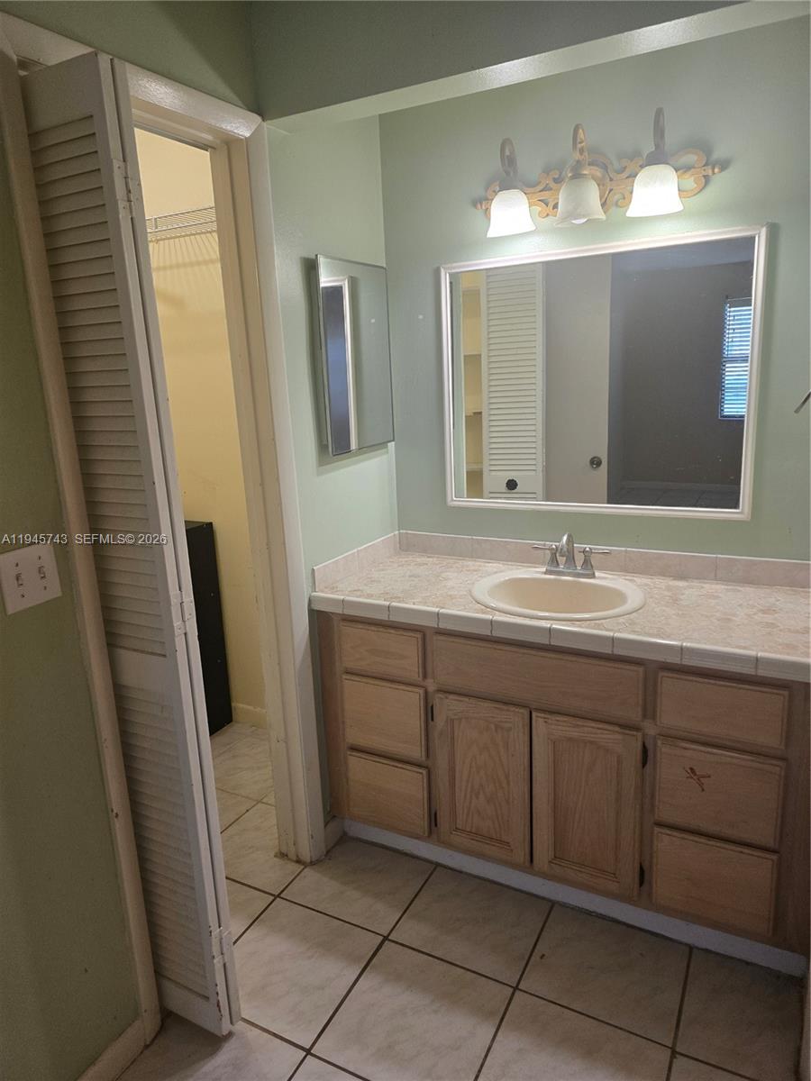 1322 Sandpiper Boulevard, Unit 1 Homestead, FL 33034 - Photo 10 of 25 a bathroom with a double vanity sink mirror and