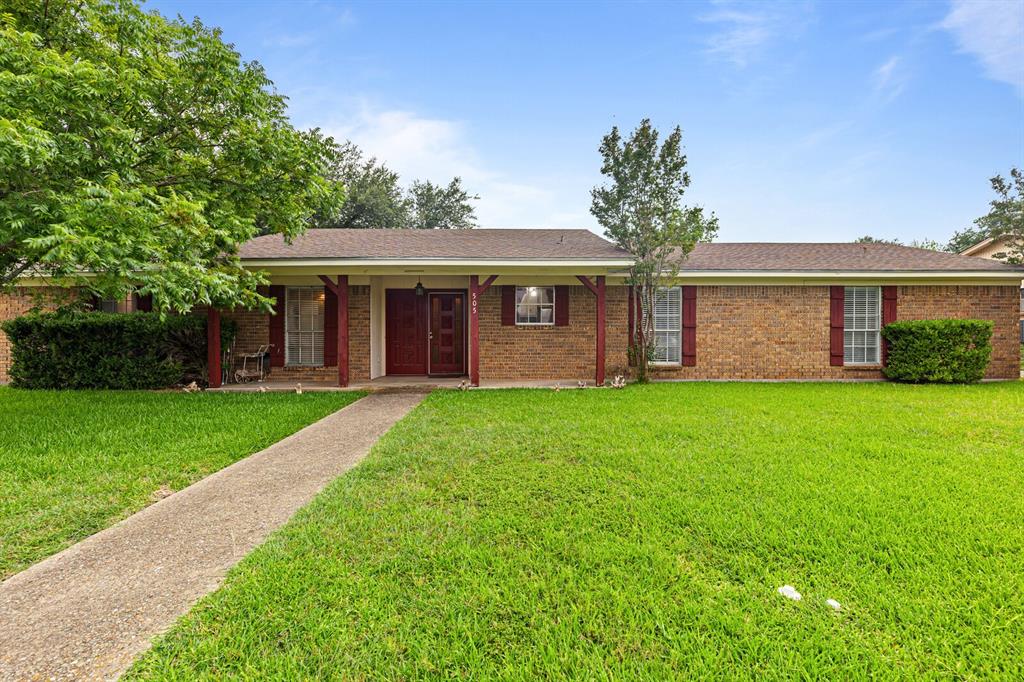 505 Pinewood Lane Hewitt, TX 76643 - Photo 35 of 38 Brick exterior with a covered entryway, red shutters, and a concrete walkway