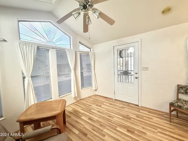 a spacious bedroom with a bed and a chandelier