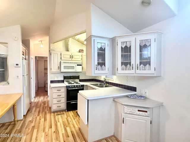 a kitchen with a sink stove and refrigerator