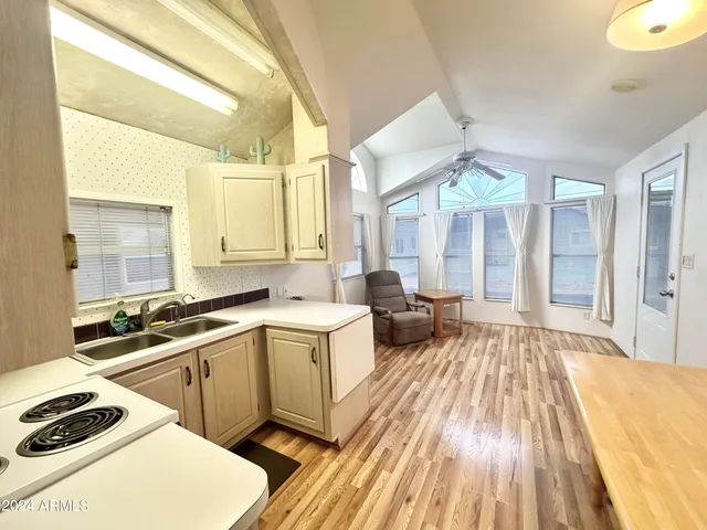 a view of a kitchen with a sink and cabinets