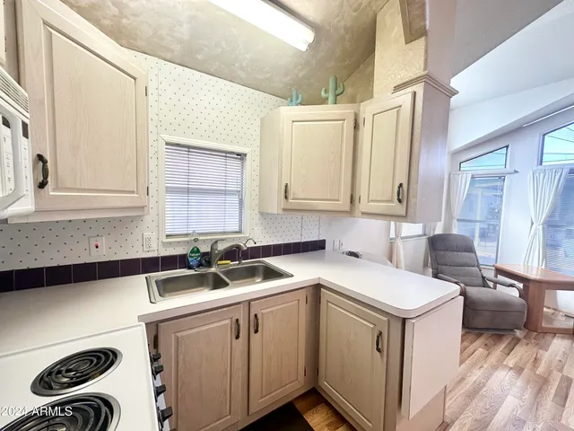 a kitchen with granite countertop cabinets stainless steel appliances and a sink