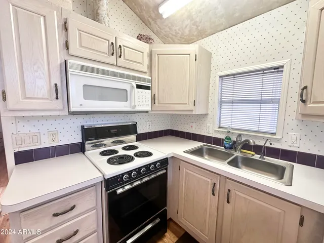 a kitchen with cabinets and a stove top oven