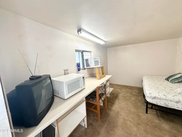 a view of a white house with wooden walls and floor to ceiling window