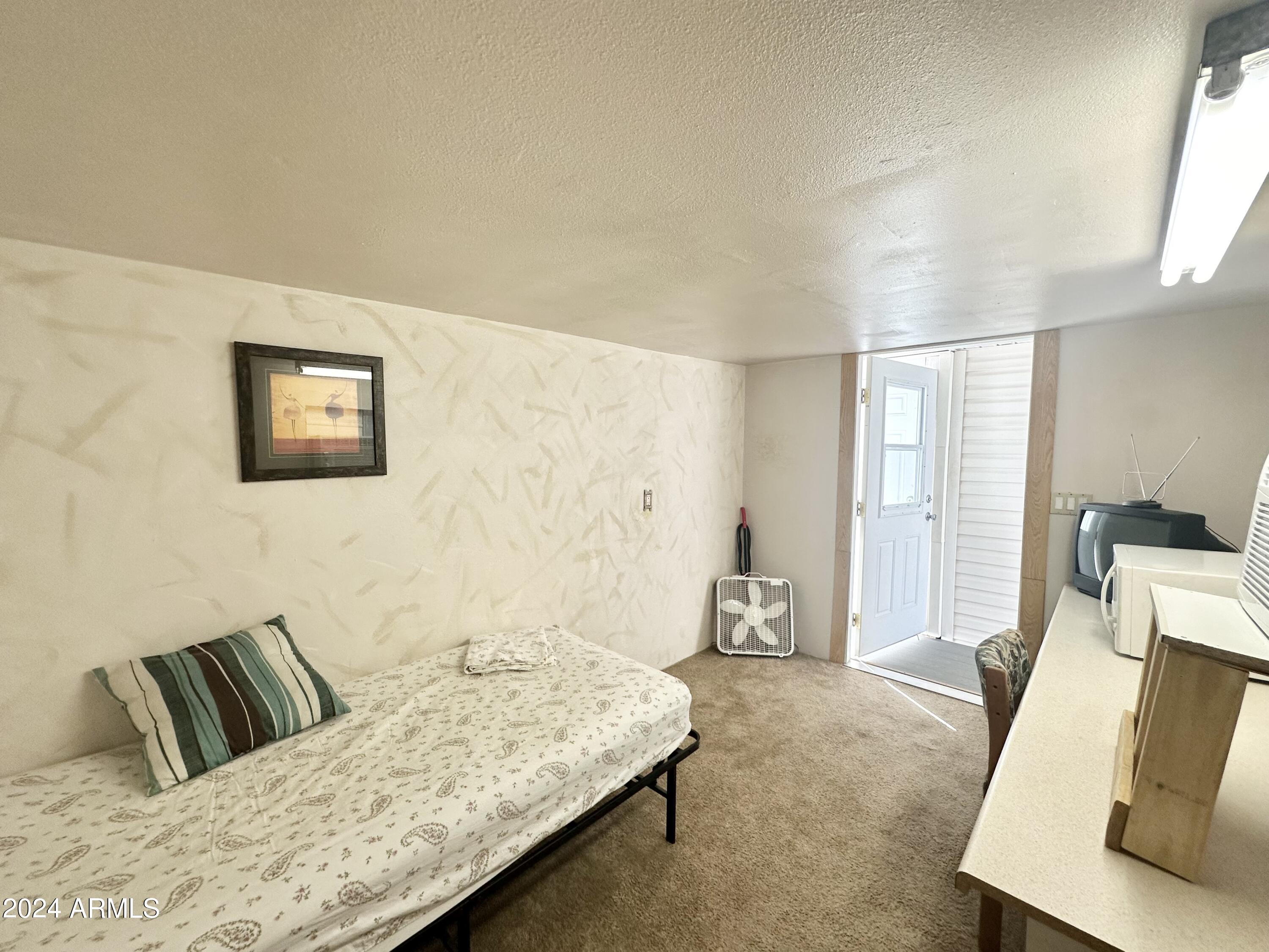 155 South Limestone Drive Apache Junction, AZ 85119 - Photo 37 of 47 a living room with furniture and a couch