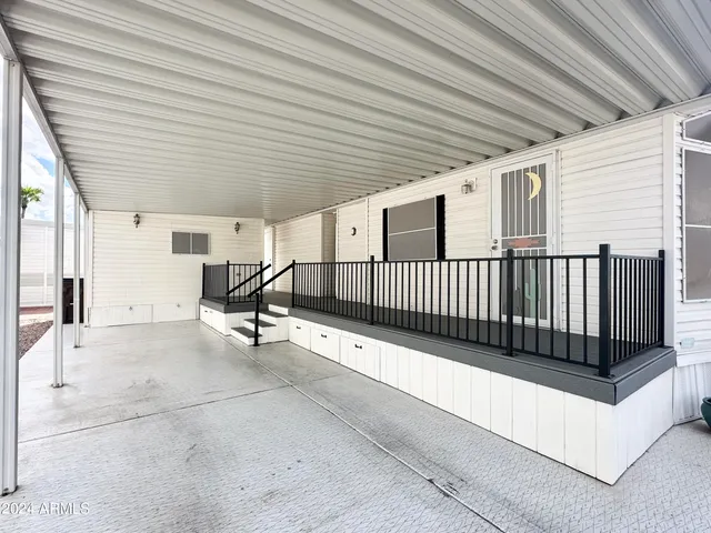 a view of a porch with wooden fence