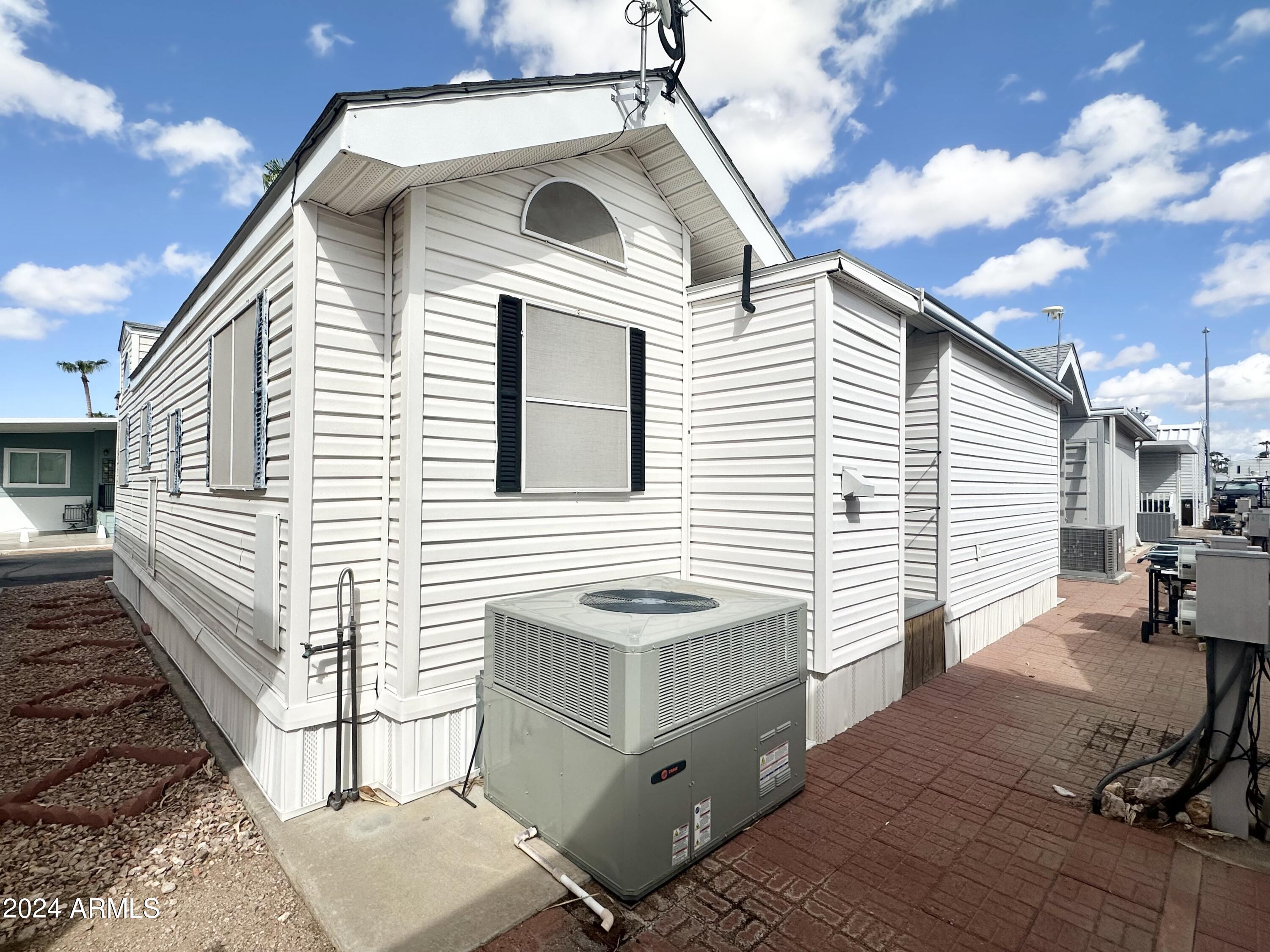 155 South Limestone Drive Apache Junction, AZ 85119 - Photo 41 of 47 a view of a white house with wooden walls and floor to ceiling window